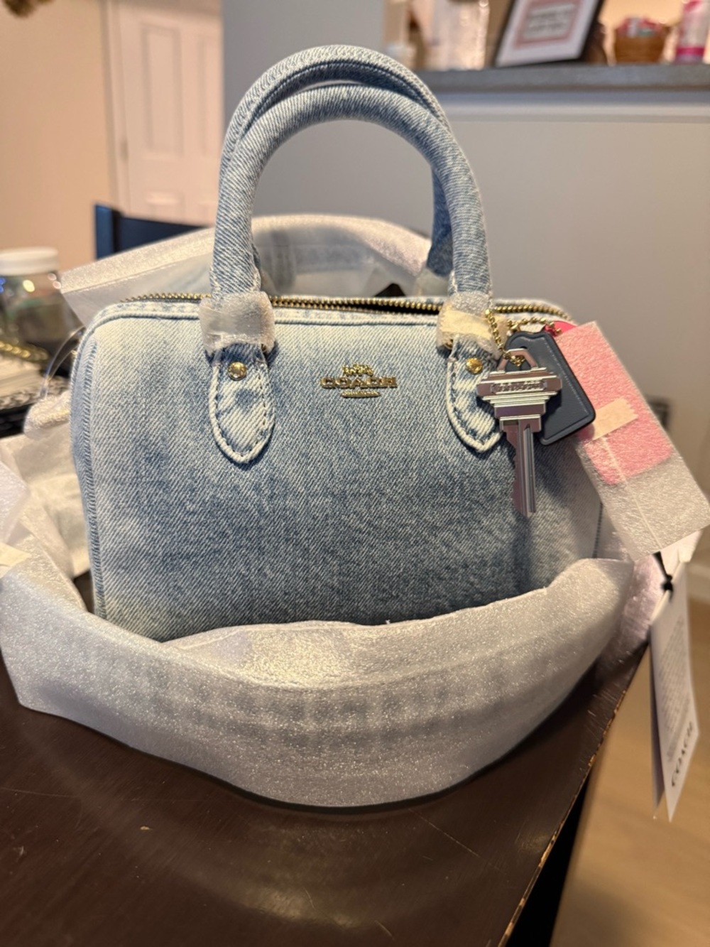 Coach Mini Rowan Crossbody Bag
In Loved Denim With Charms